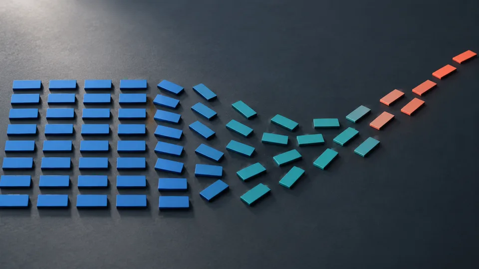 Flat blue and turquoise aluminum tiles reorganize into a new direction on a charcoal surface.