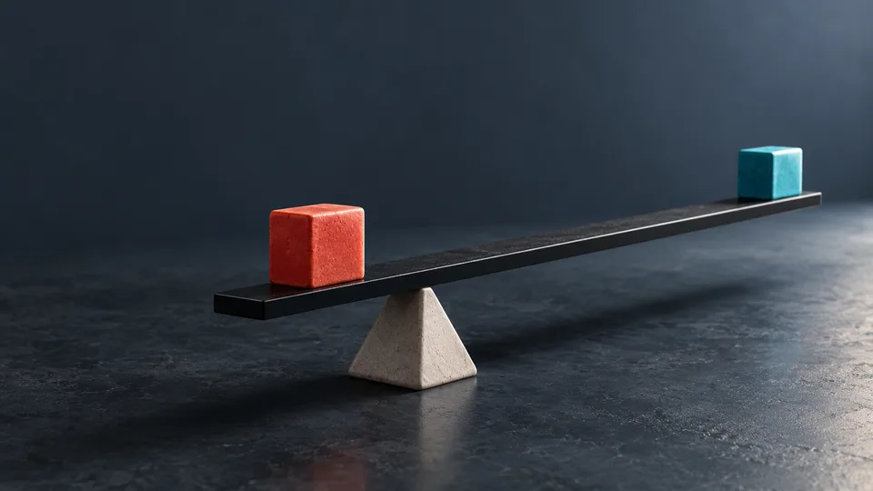 Red and turquoise blocks sit at opposite ends of a narrow beam balanced on a central pivot.